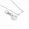 Silver bone charm necklace and matching keychain detail